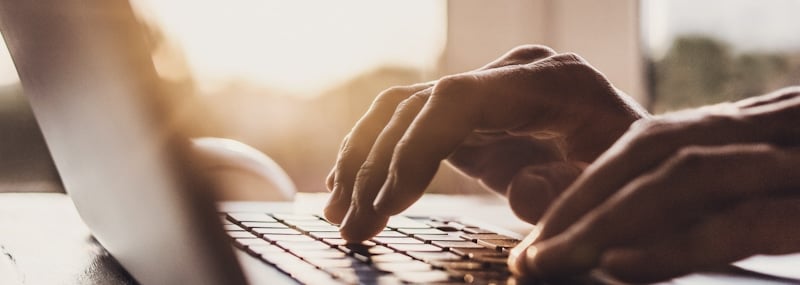 hands typing on keyboard