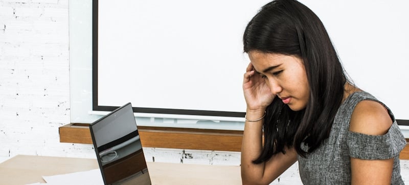 jaded girl sits in front of computer