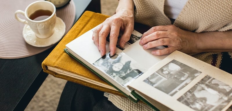 old ladys hands looking at photographs