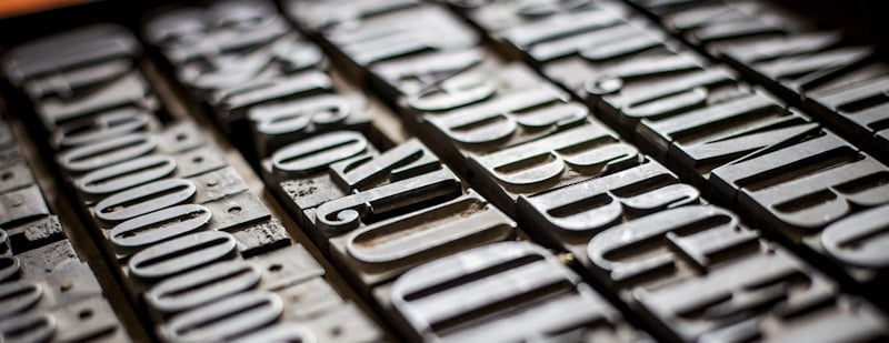 capital letters engraved in metal with embossing