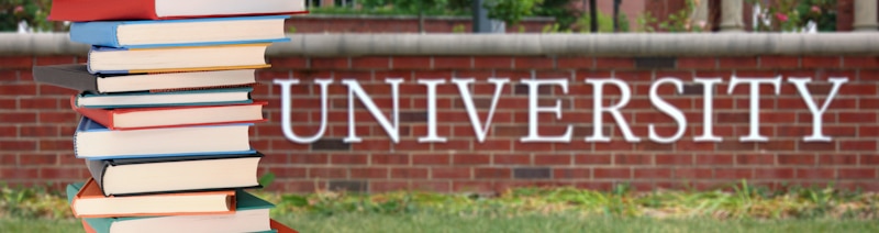 university sign on brick wall with books