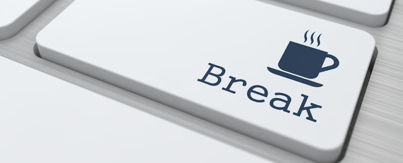 break written on keyboard with coffee cup
