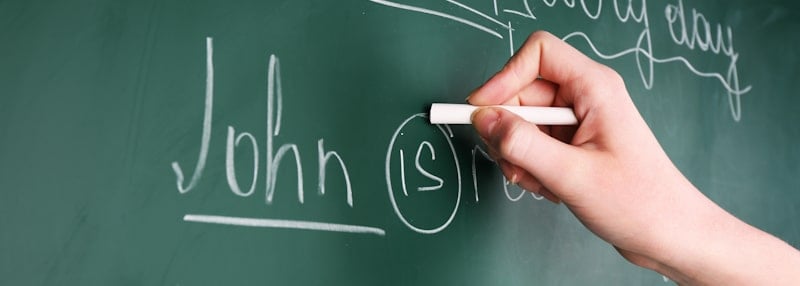 grammar lesson hand written on chalkboard