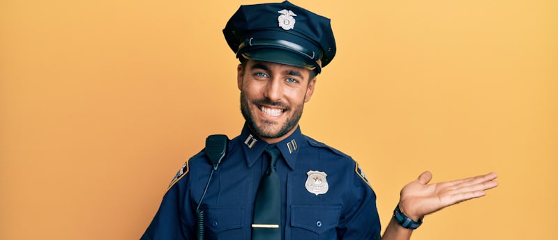 handsome happy officer in yellow background