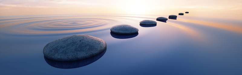 line of rocks in calm water