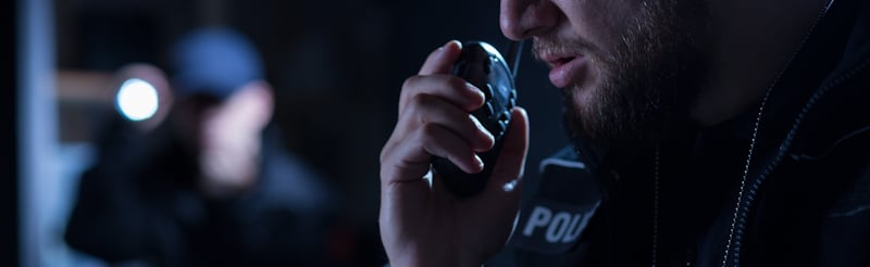 officer speaks on walkie talkie