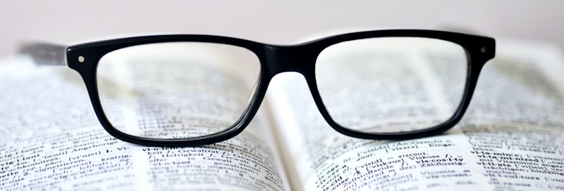 reading glasses on top of dictionary