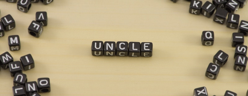 word uncle spelled with black dices