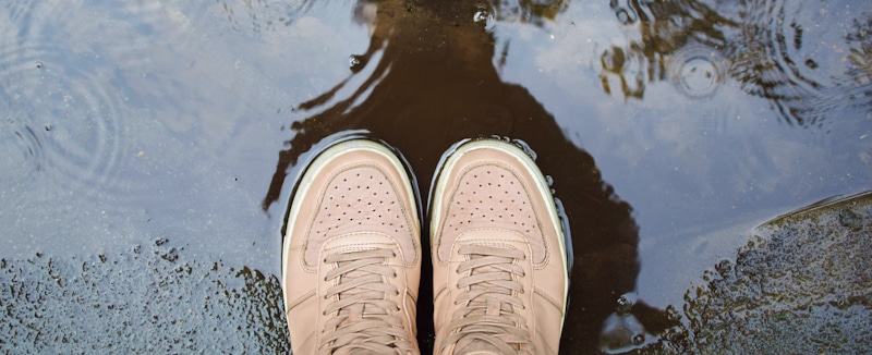 wet sneakers in puddle after the rain