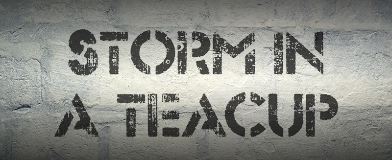 a storm in a teacup sign sprayed in concrete wall