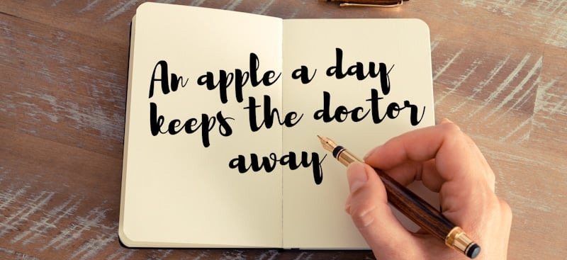 an apple a day keeps the doctor away written in blank notepad 1