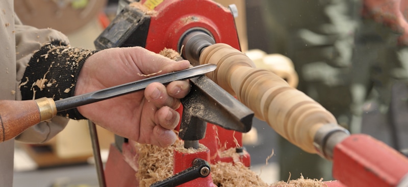 lathe being used to shape wood