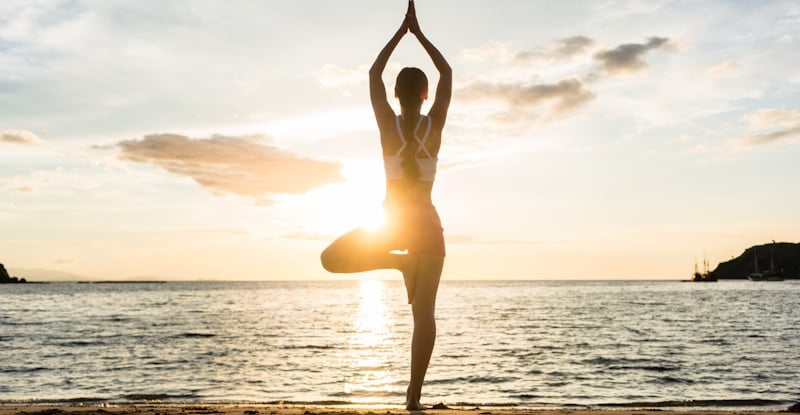 girl keeps balance as she practices yoga