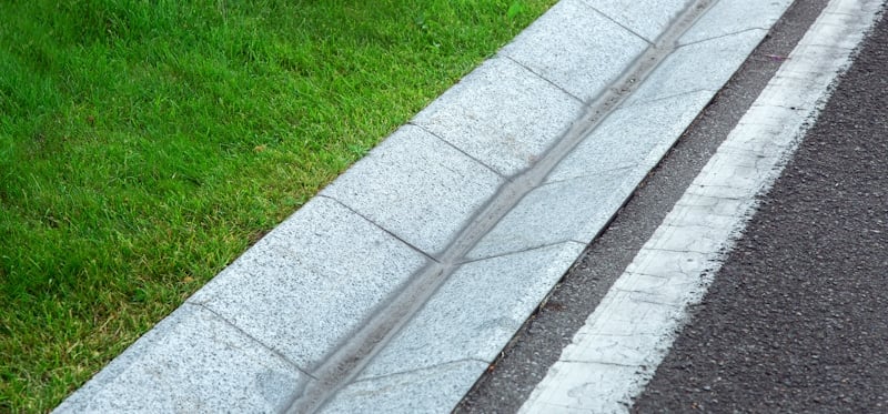 pedestrian gutter next to grass