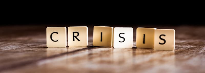 crisis sign spelled with scrabble letters