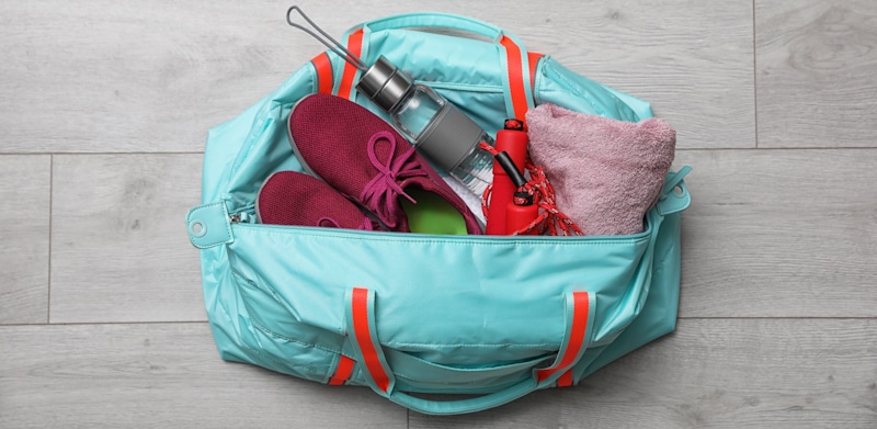 teal duffle bag with gym clothes