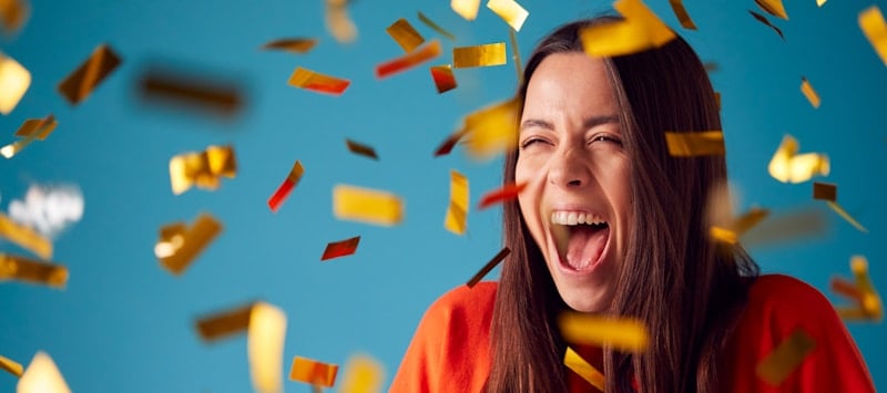 girl celebrates a win surrounded by confetti