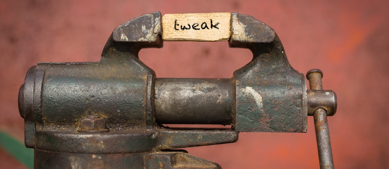 tweak word spelled on wood block