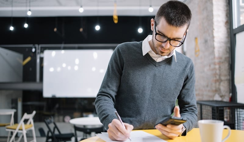 writing young man gray shirt