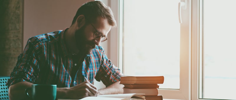 men writing a book